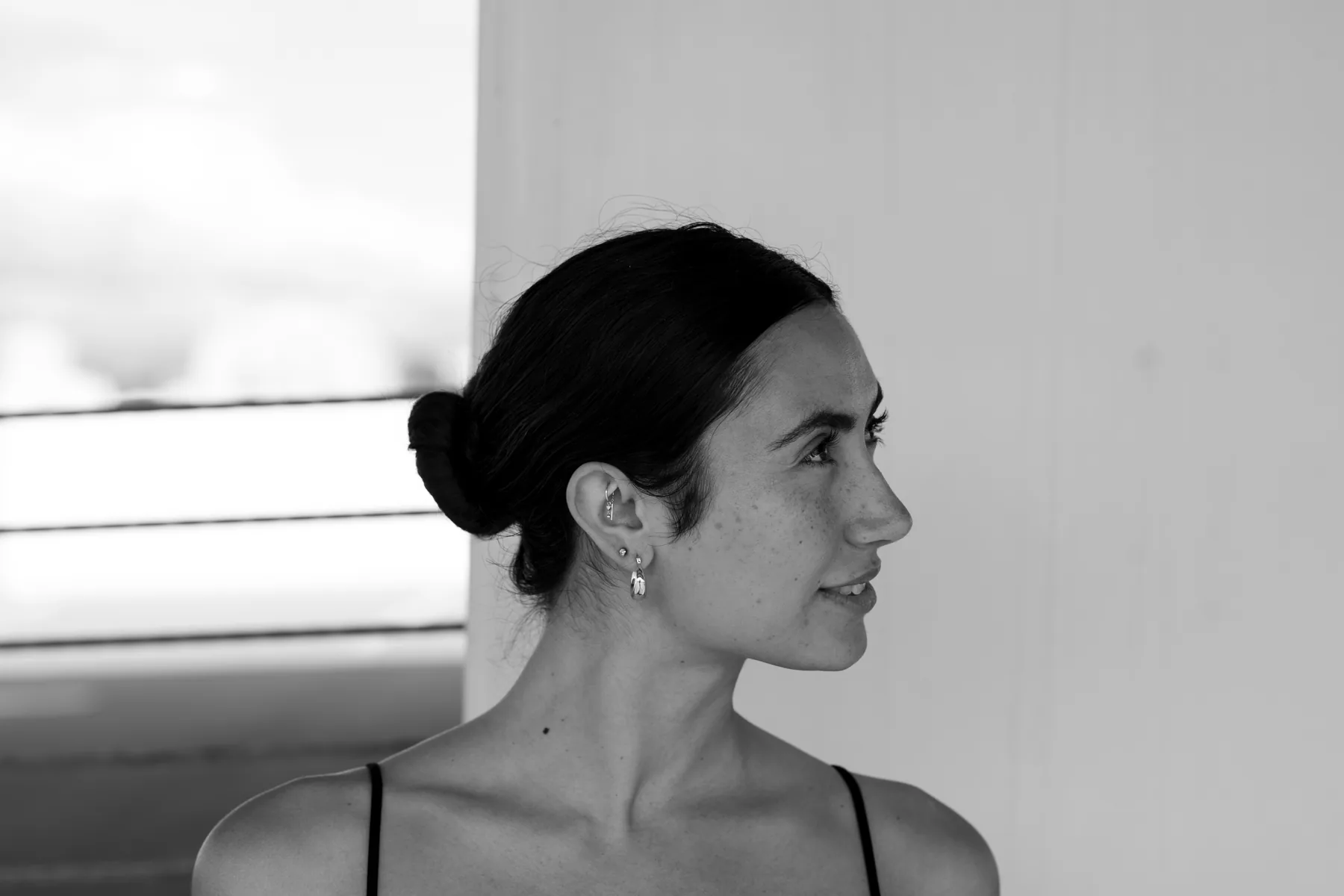 Side profile portrait in soft light, minimal styling, elegant silhouette, contemplative and intimate mood
